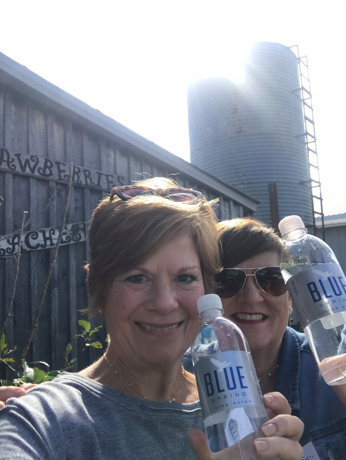 Blue Spring Living Water fan holding a bottle of spring water
